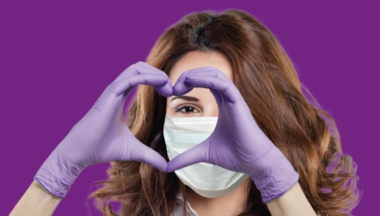 Nurse with heart shaped hands on purple